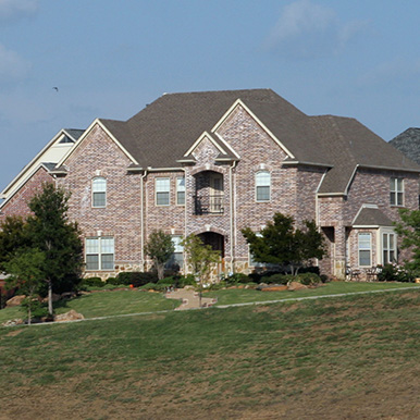 Exterior of brick home in Aledo by Platinum Painting