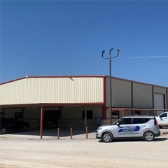a white building with cars parked nearby