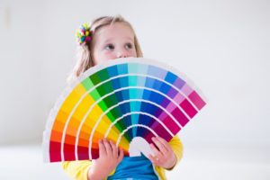 child holding paint cards