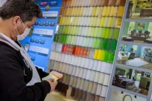 person browsing a wall of paint swatches