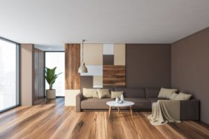 a dark-colored living room with lots of natural light