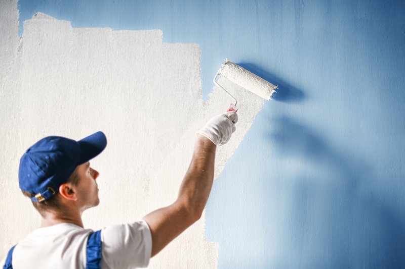 professional painter painting wall