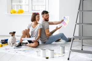 a couple painting their home with their dog 